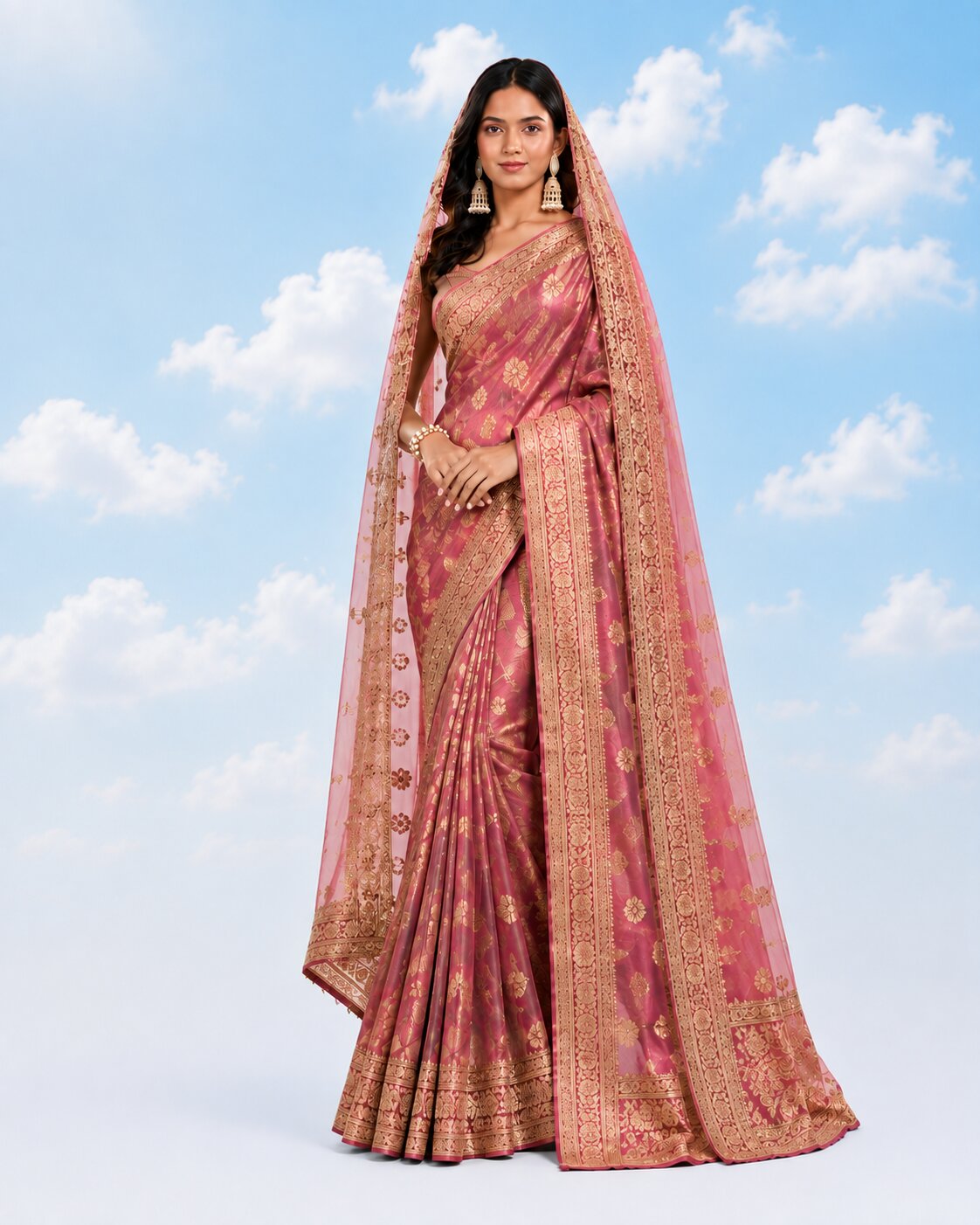 Model wearing a bridal rose-pink saree with gold zari border and a matching net dupatta